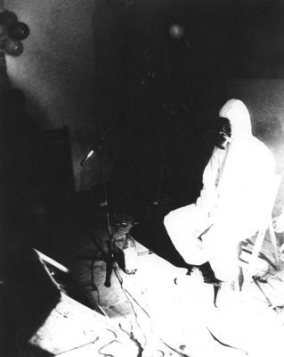 man wearing gas mask sitting on stage